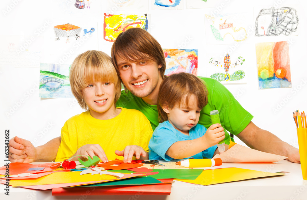 Fototapeta premium Little boys and father craft with glue