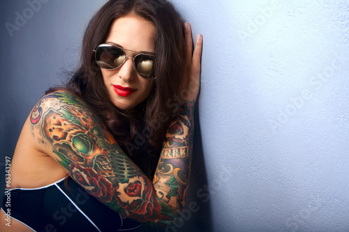 Beautiful girl with stylish make-up and tattooed arms,,
