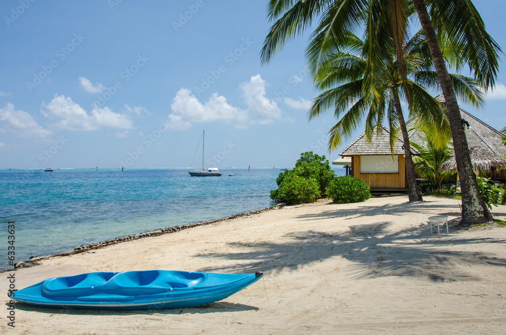 Blue kayak on beach on a tropical island