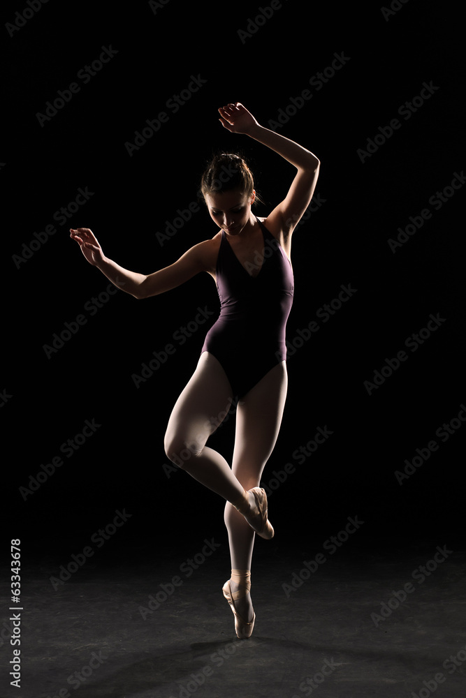 Silhouette ballet dancer in black swimsuit