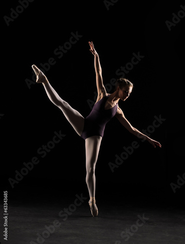 Silhouette ballet dancer in black swimsuit