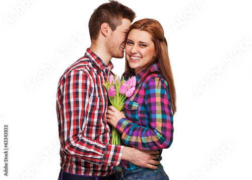 Young couple in love holding a bouquet of tulips.