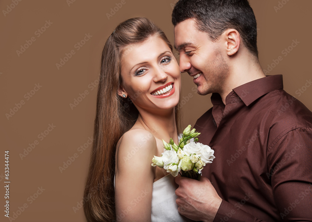 Beautiful couple in love with flowers tulips.Valentine's Day Beautiful couple in love with flowers tulips.Valentine's Day