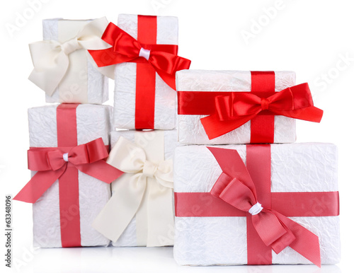 Beautiful gifts with red ribbons, isolated on white photo