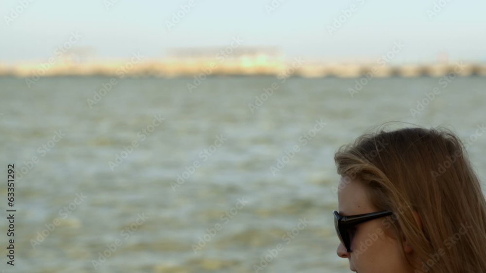 Woman using pad by the sea Woman using pad by the sea