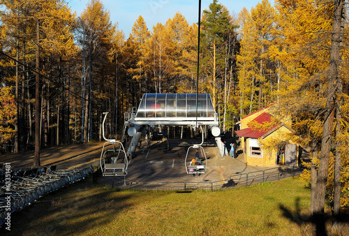 Landing place on chair lift in autumn mountain forest