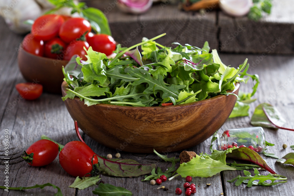 Green salad leaves in a wooden bowl