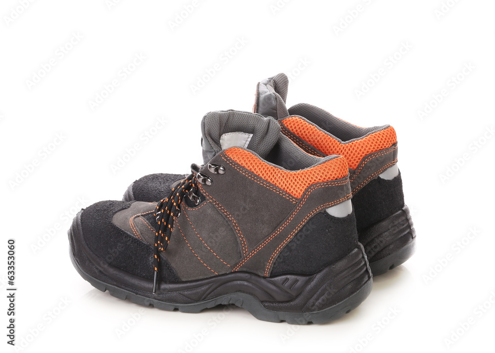 Pair of black and orange men boots. Pair of black and orange men boots.