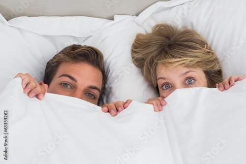 Relaxed young couple together in bed