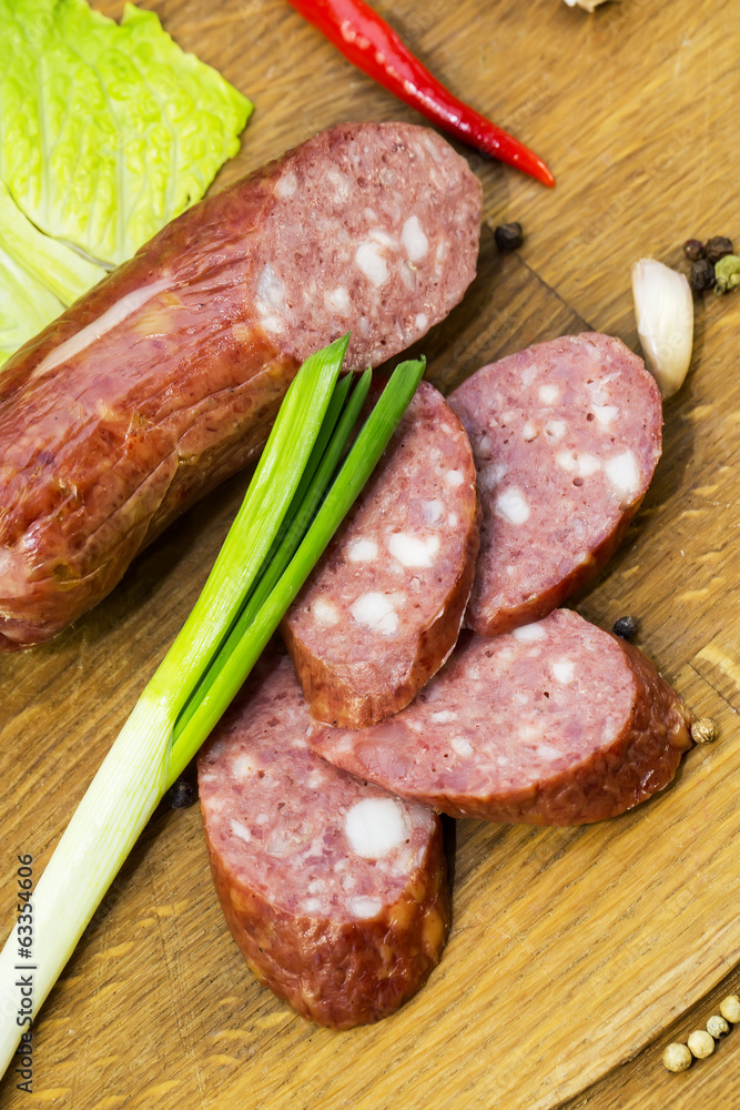 sausage on a wooden plate in a restaurant sausage on a wooden plate in a restaurant