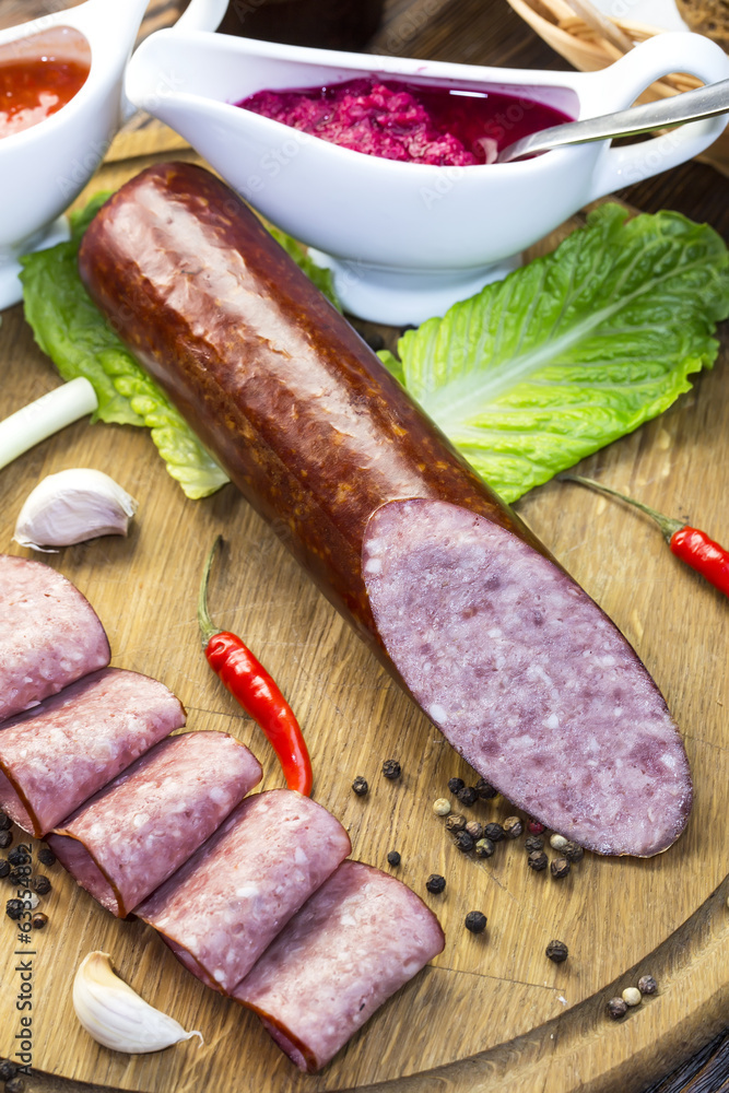 sausage on a wooden plate in a restaurant sausage on a wooden plate in a restaurant