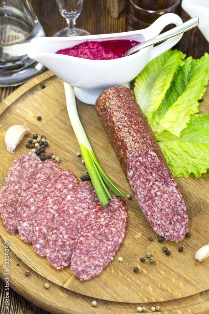 sausage on a wooden plate in a restaurant sausage on a wooden plate in a restaurant
