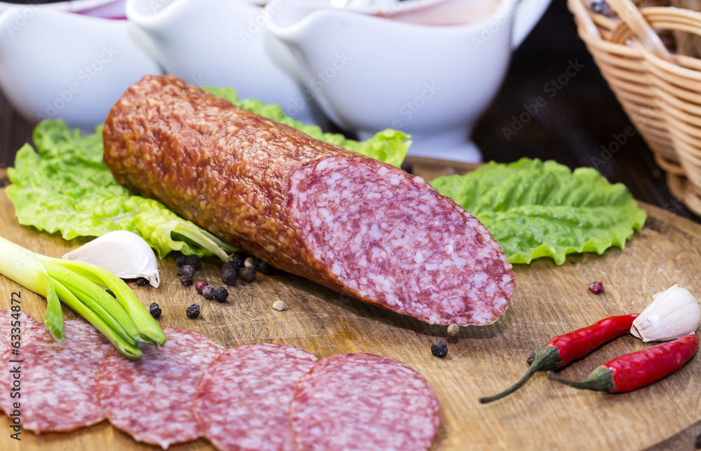sausage on a wooden plate in a restaurant sausage on a wooden plate in a restaurant