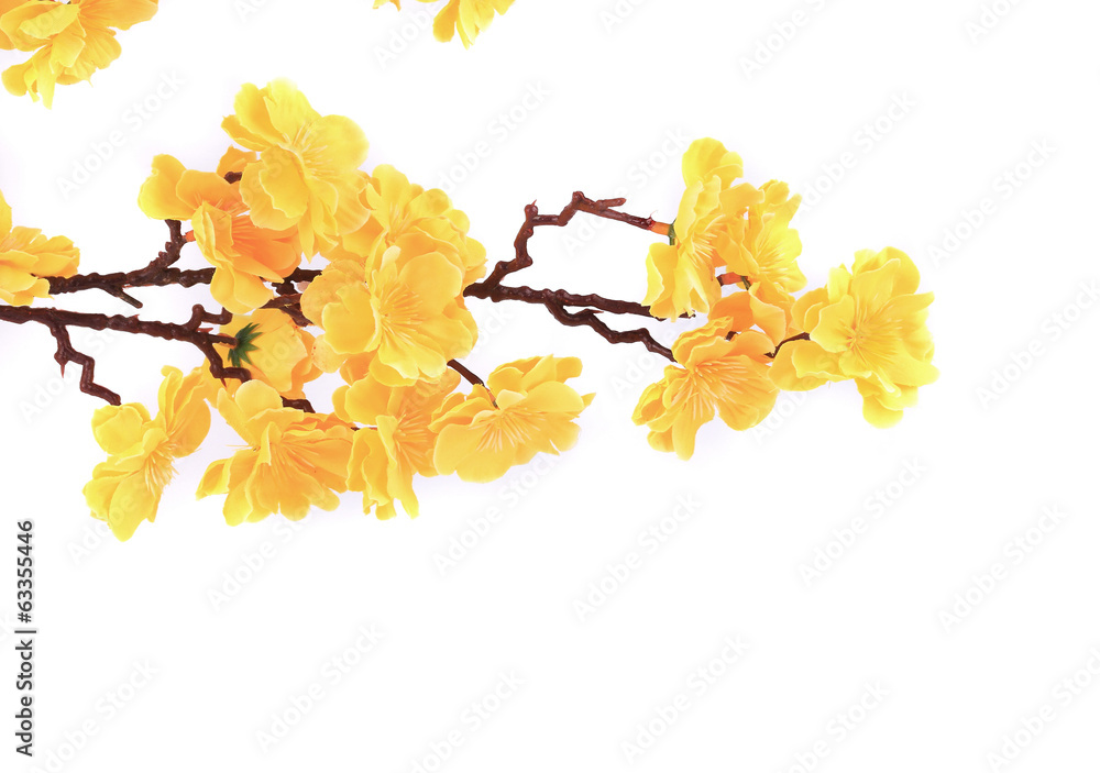 Artificial branch with yellow flowers.