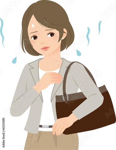 蒸し暑い日に汗や臭いを気にするビジネスウーマン