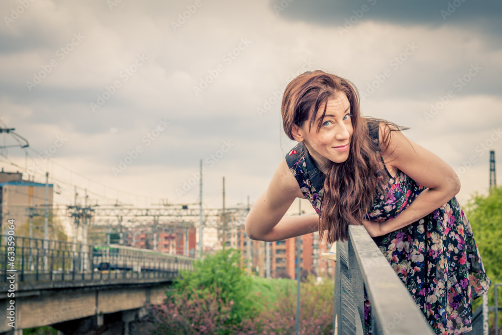 Pretty girl posing on railroad bridge