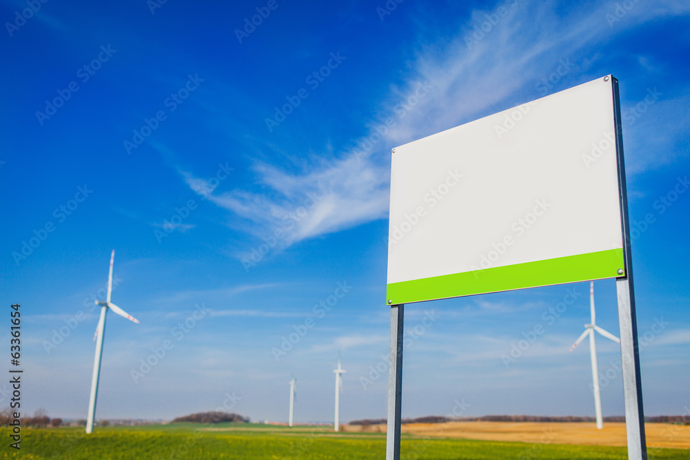 Blank board on area with energy windmills Blank board on area with energy windmills