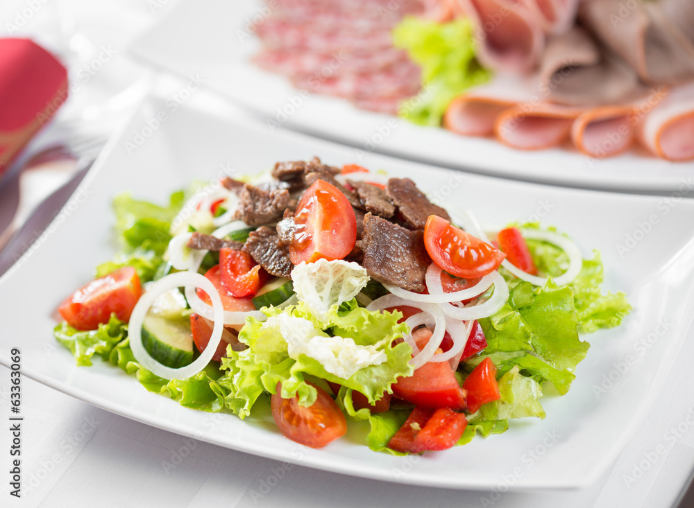 Vegetable salad with beef meat in restaurant