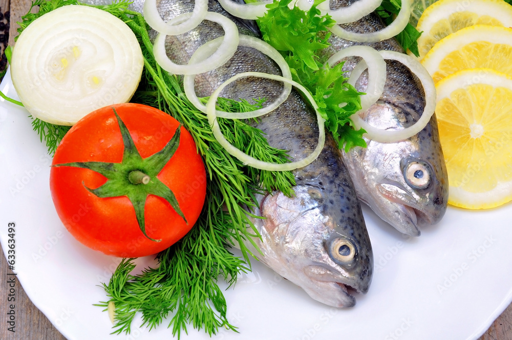 two rainbow trout with lemon and fresh vegetables two rainbow trout with lemon and fresh vegetables