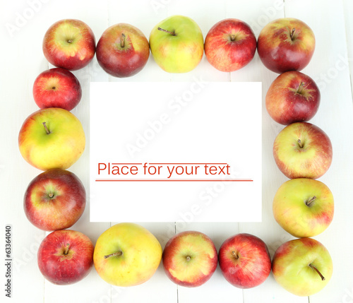 Juicy apples on white wooden table