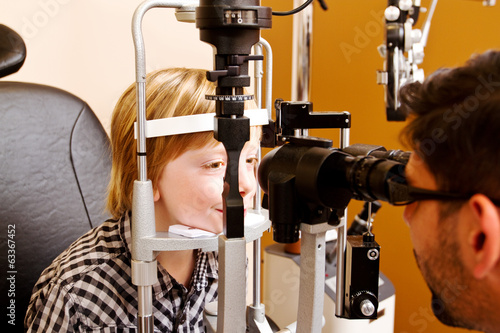 Optometrist checking childs vision