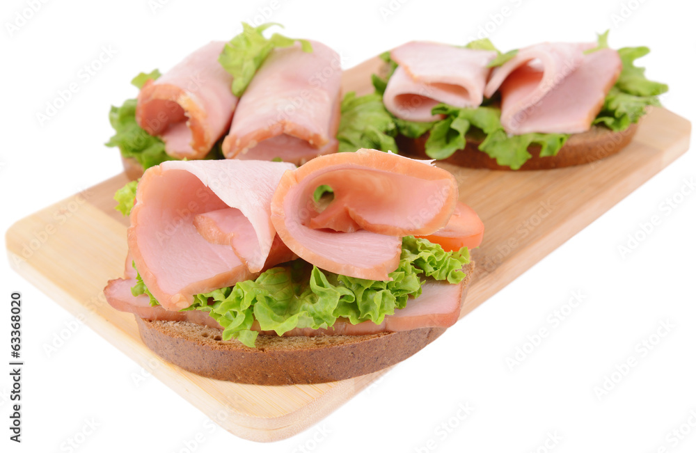Delicious sandwiches with lettuce and ham isolated on white Delicious sandwiches with lettuce and ham isolated on white