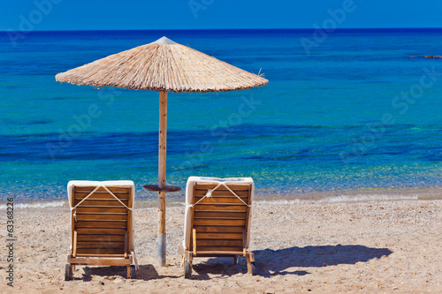 view of the beach with chairs and umbrellas