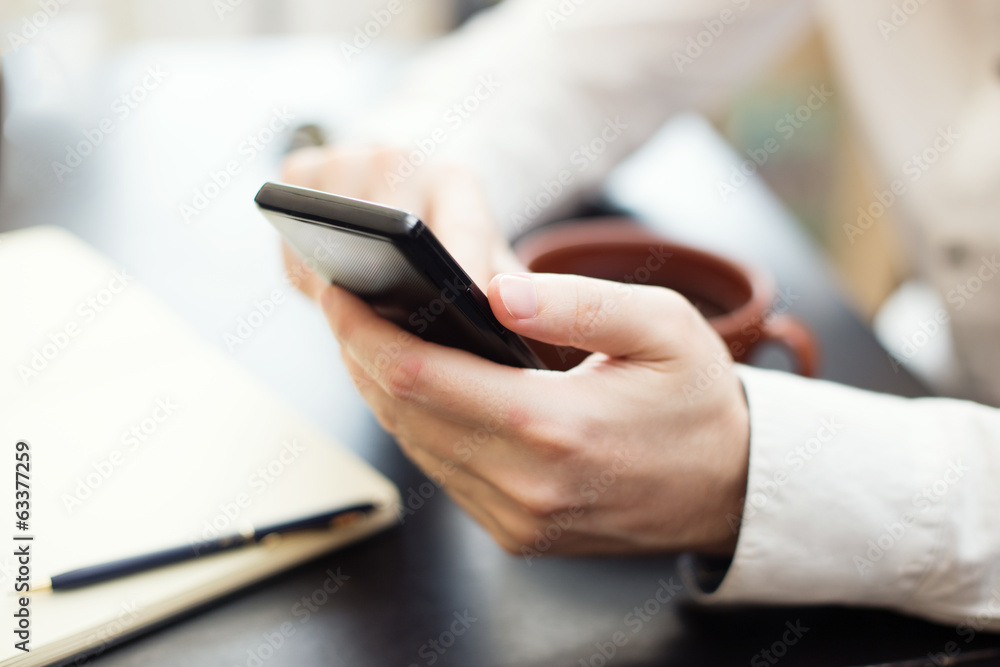 Man using smartphone, close-up photo