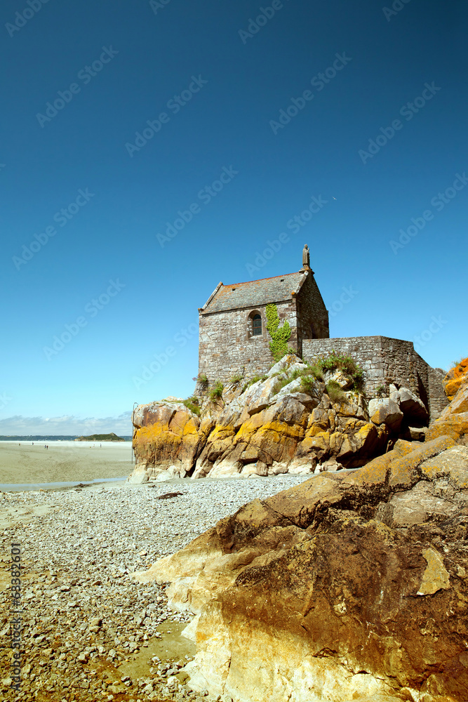 The small building on sea brink in low tide, Mont St Michel