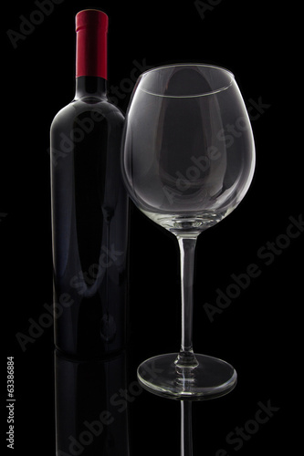 Red wine and empty glass isolated on background
