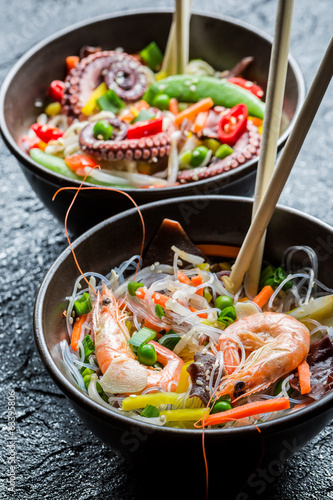 Seafood and vegetables served with noodles