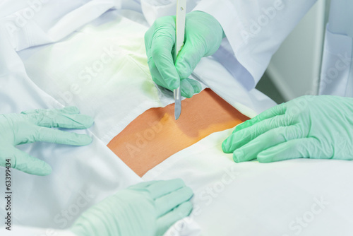 Surgeon works with a scalpel