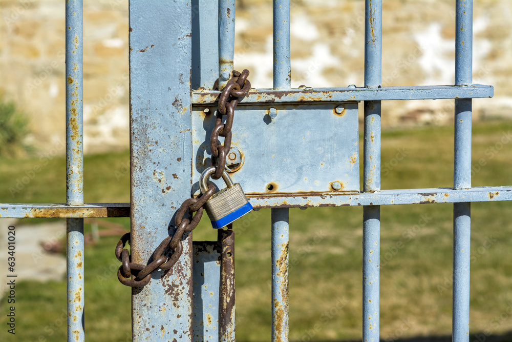 Outside prison gate with a locked chain Outside prison gate with a locked chain