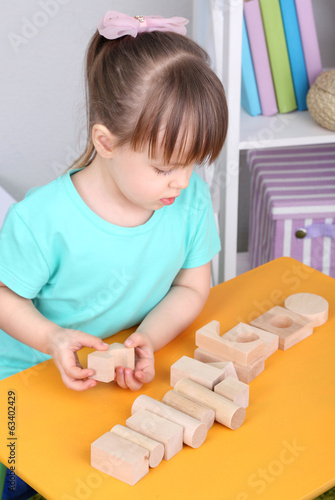Little girl plays with cons...
