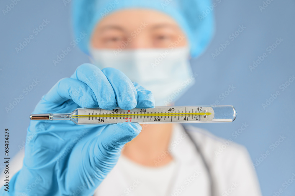 Nurse holds thermometer Nurse holds thermometer