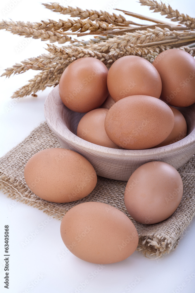 eggs in a wooden bowl on a linen canvas eggs in a wooden bowl on a linen canvas