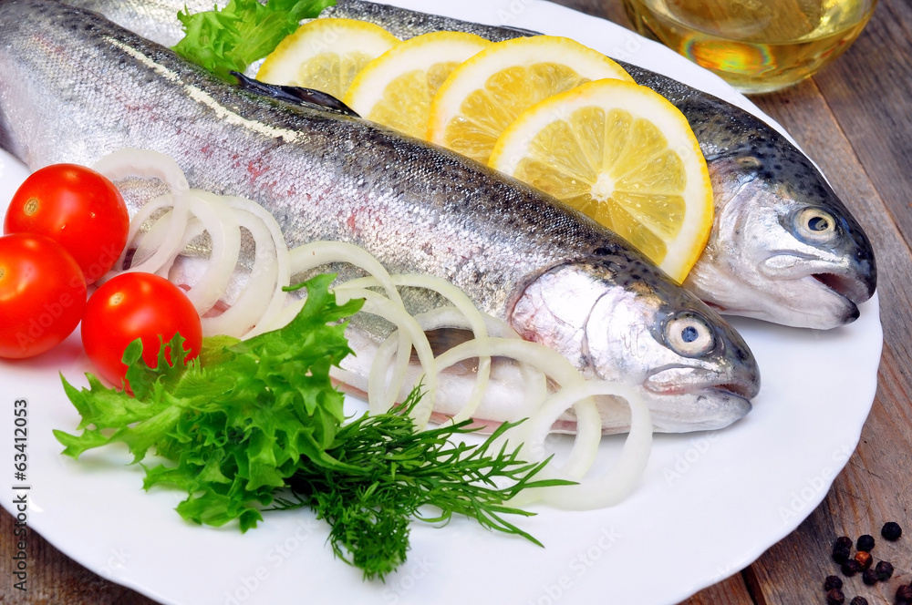 two rainbow trout with lemon and fresh vegetables two rainbow trout with lemon and fresh vegetables