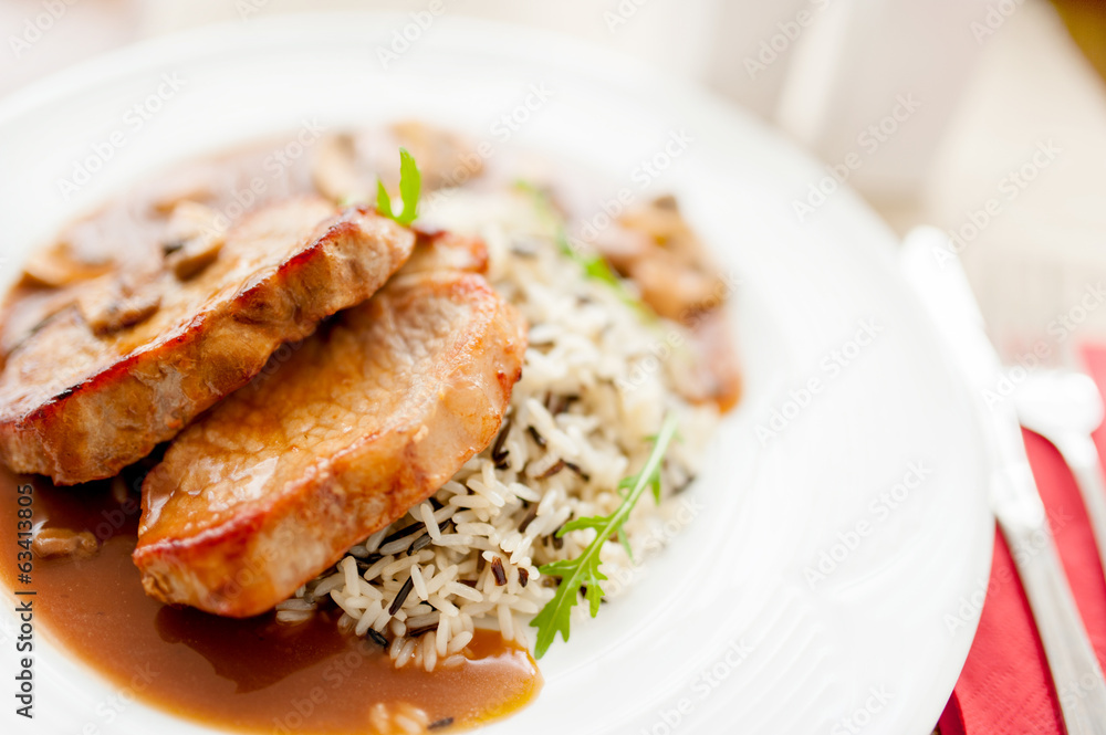 grilled succulent pork chop and rice as main course grilled succulent pork chop and rice as main course