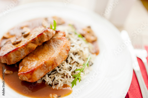 grilled succulent pork chop and rice as main course