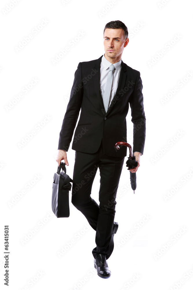 Confident businessman walking with laptop bag Confident businessman walking with laptop bag