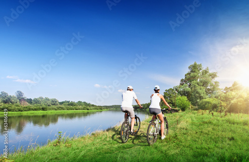 Young couple riding bicycles outdoors