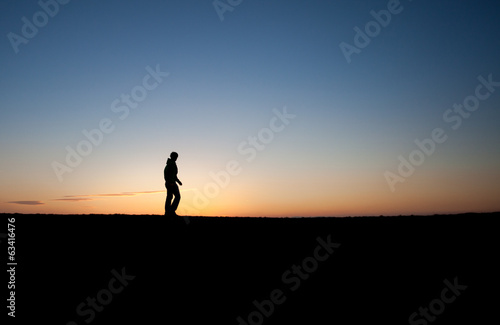 silhouetted man in sunset