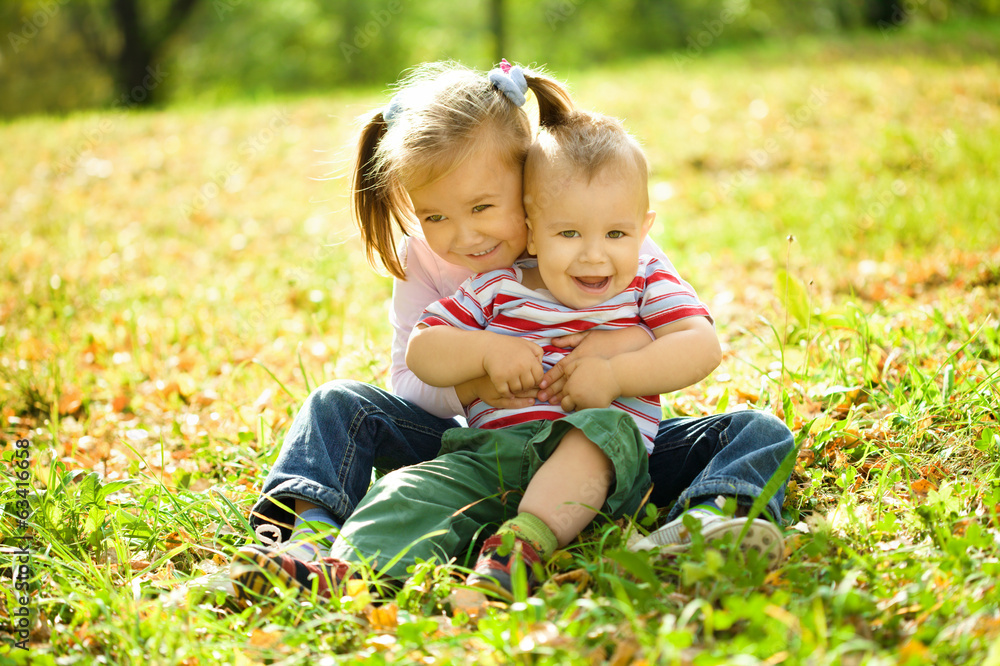 Children are playing in autumn park Children are playing in autumn park