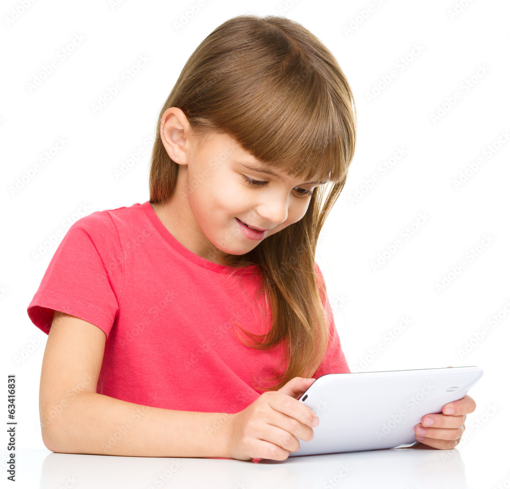 Young girl is using tablet while studying Young girl is using tablet while studying