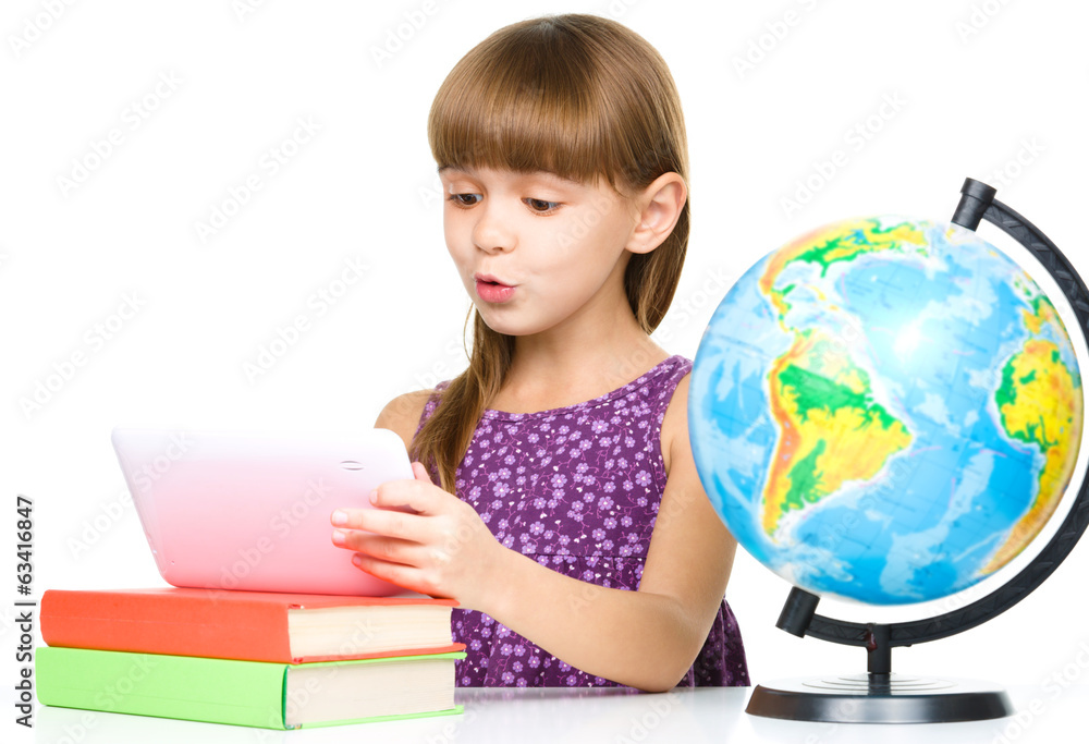 Young girl is using tablet while studying Young girl is using tablet while studying