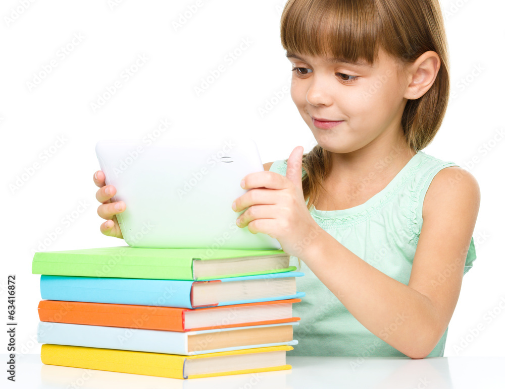 Young girl is using tablet while studying Young girl is using tablet while studying