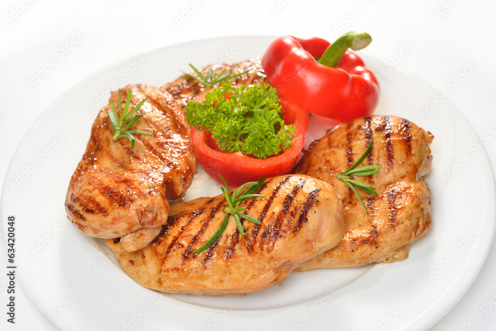 Grilled chicken breast with vegetables on white plate. Grilled chicken breast with vegetables on white plate.