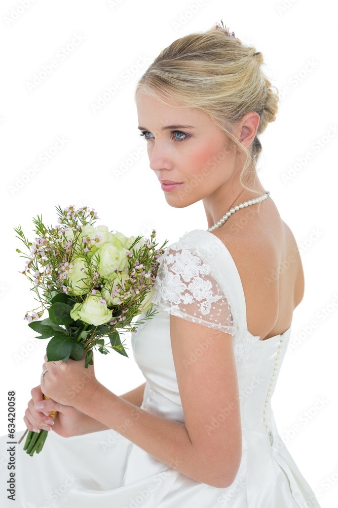 Thoughtful bride holding flower bouquet Thoughtful bride holding flower bouquet