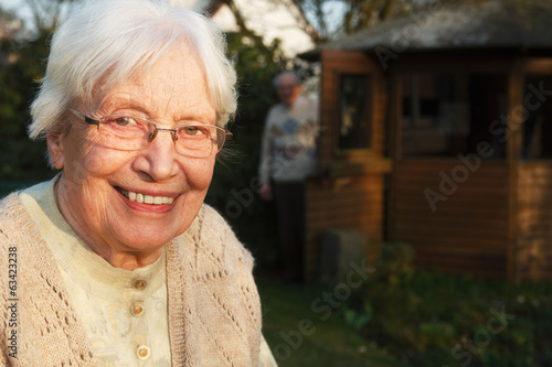 Elderly woman with walking frame in the garden photo