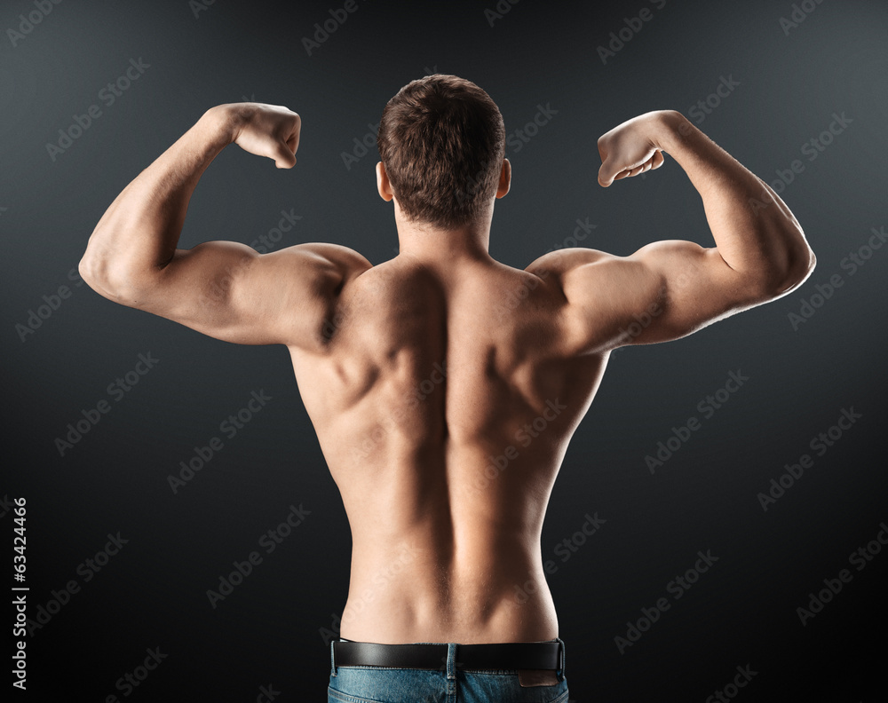 Fototapeta premium bodybuilder showing muscles back and arms